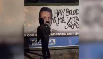 Militante antiaborto se filmó dibujándole rasgos de Hitler a cartel de Massa